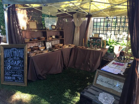 Outdoor market stall with handmade soaps and artisanal products from Luna Herb Co. & The Smelly Gypsy.