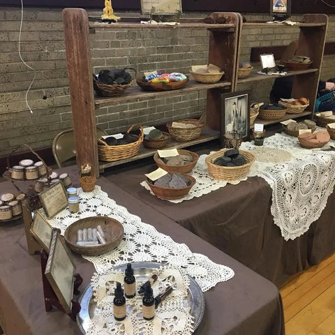 Handmade and vintage items on lace doilies at Luna Herb Co. & The Smelly Gypsy display table.