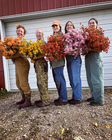 People holding vibrant bouquets of colorful flowers at Delight Flower Farm: A Sustainable Oasis.