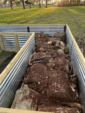 Raised garden bed with soil, rocks, and plant debris in farming career article.