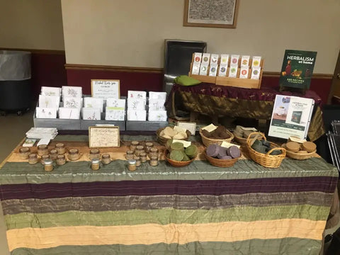 Display table of herbal products and teas from Luna Herb Co. & The Smelly Gypsy.