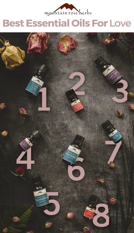 Seven essential oils for love laid out on a table.